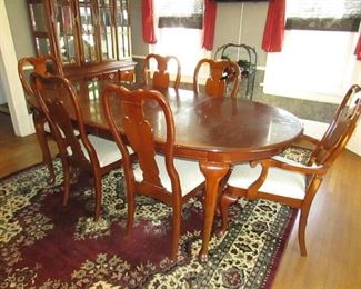 Queen Anne-style dining table with cherry finish and (2) leaves, (4) side chairs, and (2) arm chairs. Top in need of refinishing chairs in need of re-upholstering. 7' long table with 2 leaves. 42"w X 29.5"h. As-Is. PRICE: $195.00