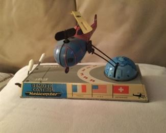 Remote control helicopter, well at least the very old fashioned definition of remote, anyway! 1950s Biller Bahn clockwork wind up tin toy with great colors, aknd works. Wind up the helicopter for the blades to spin and wind up the plane to spin around in a circle Sold at Catawiki for 130 euros, on eBay at 189. With box, and lofty 75. Sorry no box, but the deal price of $45.00