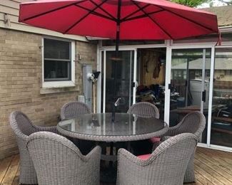 Crate and Barrel resin wicker 60” diameter table with glass top, umbrella and 6 chairs with pads - $1200