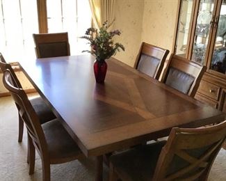 Superb dining room table and 6 chairs!  There are 2 leaves and a padded topper.