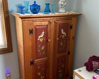 Tole design wooden cabinet, blue glass ware