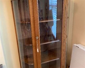 Curio cabinet with curved glass