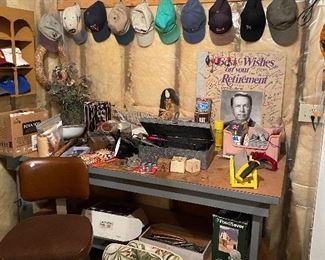 Baseball hat collection, work bench, vintage swivel chair, retirement poster in the back is signed by the creator of Post It notes