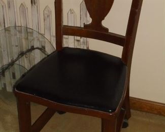 Vintage wood chair w/black padded seat & castors