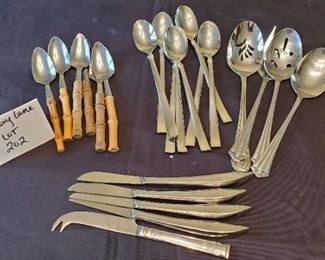 $10 - 6 grapefruit spoons, 8 long tea spoons, 4 serving utensils & 5 knives
