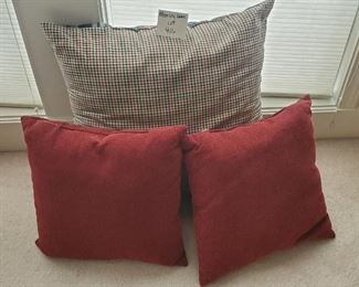 $12 - 3 pillows. The largest one is reversible with plaid pattern on other side and 23".