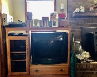 TV cabinet, Panasonic TV, VHS's, DVD's, outdoor antenna, VHS player and DVD player