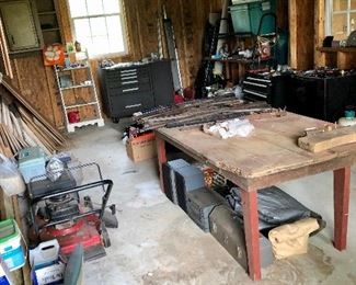 Another workshop, farm table, tool chest, push mower, tools boxes, plastic gun stocks and swords (on table)...