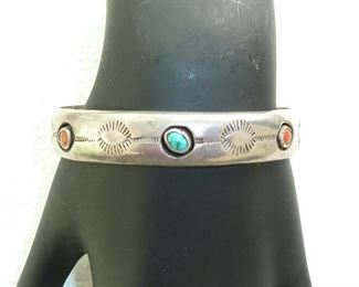 Hand stamped Native American Sterling silver turquoise and coral cuff bracelet from the 1960s or seventies.  $165