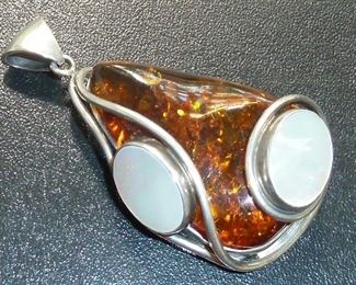 Big chunky statement pendant in Amber and Mother-of-pearl, set in Sterling silver. It is 2 3/4" tall, and weighs 36 grams.  $185