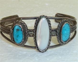 Signed but unable to decipher.  Also marked STERLING.  Vintage 60s or 70s turquoise and mother-of-pearl cuff bracelet.  One inch tall.  $175