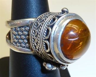 Yes yes yes!  Amber poison ring set in Sterling silver.  It is adjustable too.  More pictures available.  $225
