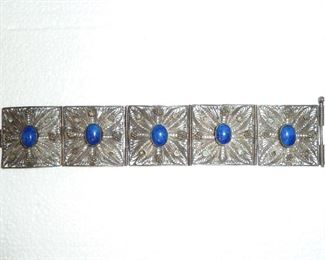 1 3/8" wide bracelet of silver filigree and lapis blue art glass stones.  Old.  $89