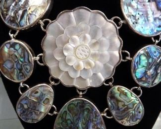 It is 4.5 inches from the top of the carved white mother-of-pearl flower to the botttom of the abalone piece below it.  HUGE fabulous Sterling silver necklace signed AF.  $375