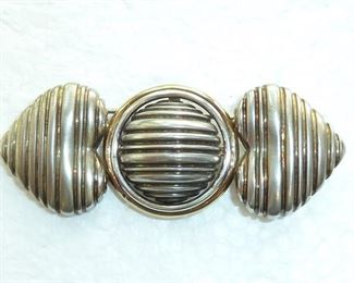 2.5" wide 18k gold and Sterling silver brooch.  Has maker's mark that looks like a dollar sign, and says STER. and 18K.  Well made quality piece.  $88