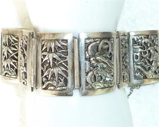Marked SILVER and FRENCH INDOCHINA, this fabulously detailed panel bracelet depicts dragons, jungle, flowers, people and more.  Very well made heavy (67g) piece.  $245