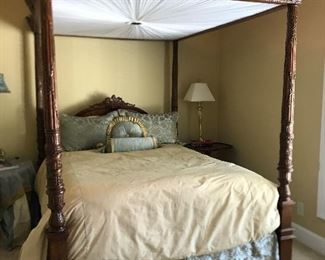 Queen size canopy bed with luxurious linens