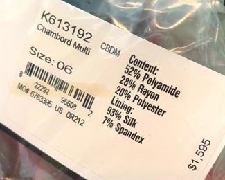 the red St. John suit has never been worn and the original tag is still attached