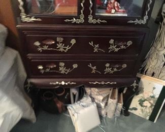 The Oriental cabinet has two large drawers. On the Floor you will see hand covered photo albums.