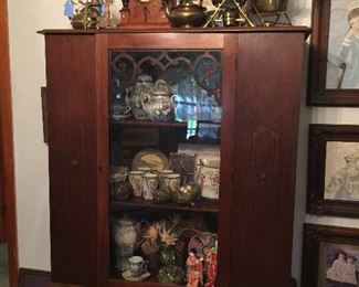 China cabinet in Living Room, Chinese and Japanese china, dolls, floral, and birds.