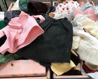 Vintage dolls and clothes with suitcase.