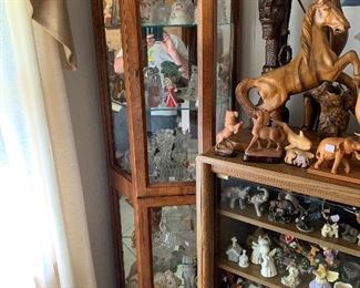 Corner curio cabinet. TV cabinet, and lots of salt and pepper shakers and knickknacks
