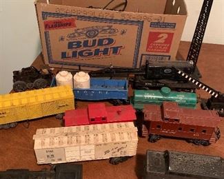 Assortment of model train, track, Lionel cars, transformers and more