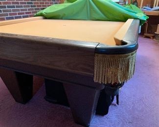 Brunswick pool table in excellent condition. Includes balls, Cue sticks, and accessories
