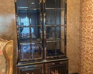 Chinoiserie Lighted Display Cabinet with hand painted gilt detail and beveled edge glass. 3 glass display shelves . 1 wood shelf inside lower cabinet. 86”H x 41”W 14”D $550.