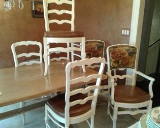 6 French Country Dining Chairs with high gloss paint and  brown leather seat cushions.  2 armchairs with oil cloth floral backs and nailhead trim.  $595. K15