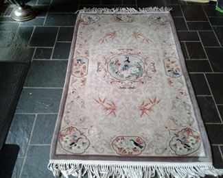 Wool oriental rug with bird motif and center medallion.  68 x 37.  $125. DR 22