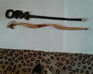 Lot of 2 wood walking sticks.  One is black animal heads and two toned curved wood.  $50.  MB4