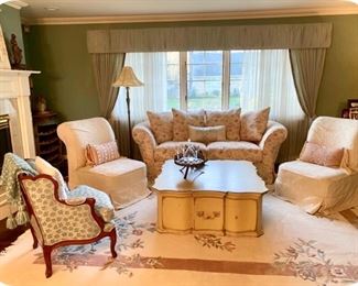 Living Room. Shabby Chic Sofa, $500.  Queen Anne Upholstered Wood Chair, $300,  Wood Storage Coffee Table, $400, Rug, 8.5’W x 11.5’L, $475