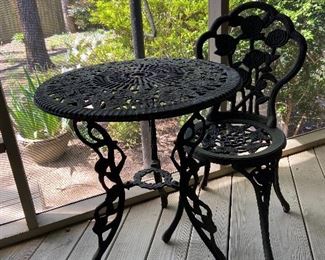 Wrought iron table with one chair. 