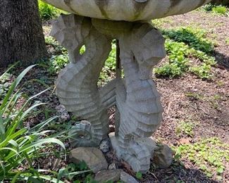 Large bird bath with seahorses.