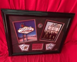 $375 “Rat Pack” Collage
Measures 28” Wide x 23” High
#50/250
Framed Collage consists of a dimensional "Welcome to Fabulous Las Vegas" famed sign, a photo of the "Rat Pack" in from of the Sands, an original casino chip from the Sahara, Playing Cards from the Sands and a signature plate of the members of The Rat Pack.
Have Certificate of Authenticity.