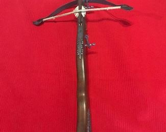 $150 Decorative Wooden Cross Bow w/Accent Pieces This is a vintage decorative wooden cross bow that has metal decorative accents. There is a "dart" resting on the top of the bow. It measures 23" long. I have additional photos with different angles.