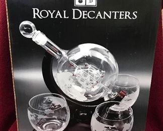$40 New Etched Glass/Glass Ship Decanter with 4 Glasses
This set consists of a glass decanter with a glass ship inside and etchings of the globe on it. It sits in a wooden cradle. The cradle has 4 holders for the 4 etched glasses that also have the globe etchings on them.