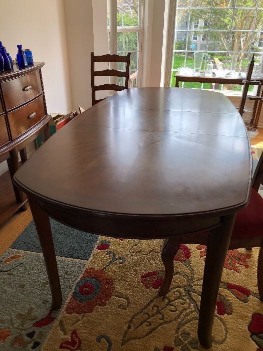 Cherry wood dining table by Ashley furniture 66" long oval with 18" leaf, 2 arm chairs and 4 side chairs $400 OBO