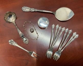 Sterling Durgin “Iris” Tomato Server - $250.  Gotham “Imperial Chrysanthemum” Sauce Ladle - $95.  Sterling Pill Box - $30.  Sterling Dolphin Bracelet - $45.  Sm Sterling Locket - $15.  Grande Baroque Olive - $35.  English Gadroon 8 Cktl Fks - $200