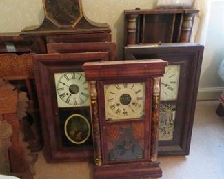 Several clock cases-some with clock works, most empty