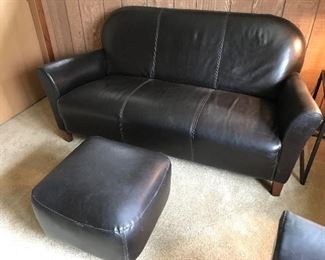 $550 - Sofa: We believe this is a Nicoletti Calia Salotti Italian Leather loveseat, 66”x34”x34”. Footrest: $45, leather, 20”x20”x15”