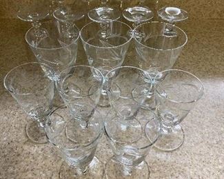 $18 - 3 Goblet, 6 wine glasses with floral or olive plant pattern, an add’l 7 goblet and 5 wine have chips or flea bites
