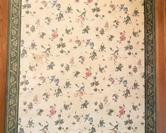 Machine woven floral rug with green border.  4'5" x 6'5".  PRICE: $120