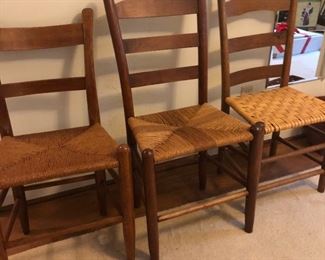 Lots of wooden chairs with woven seats