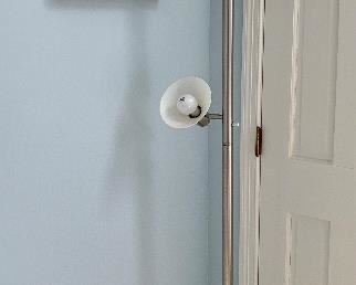 Item 9:  Standing Brushed Chrome Lamp (Fair condition, stands crooked) - 6 ft. tall: $45