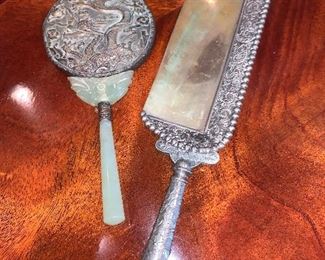 Silver-plated crumb sweeper $50.  Vintage Bakelite hand mirror $50