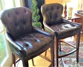 Pair of bar height brown leather tufted chairs  $350.00
