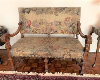 Italian 19th century love seat with tapestry back and seat, carved arms and legs. Measures 40 3/4" high by 52" wide by 29" front to back.  $850