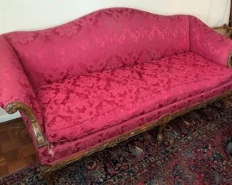 Carved wood sofa with red upholstery - shows wear and stains - good bones - measures 84" wide by 25 1/2" high by 31 3/4" front to back.  $200